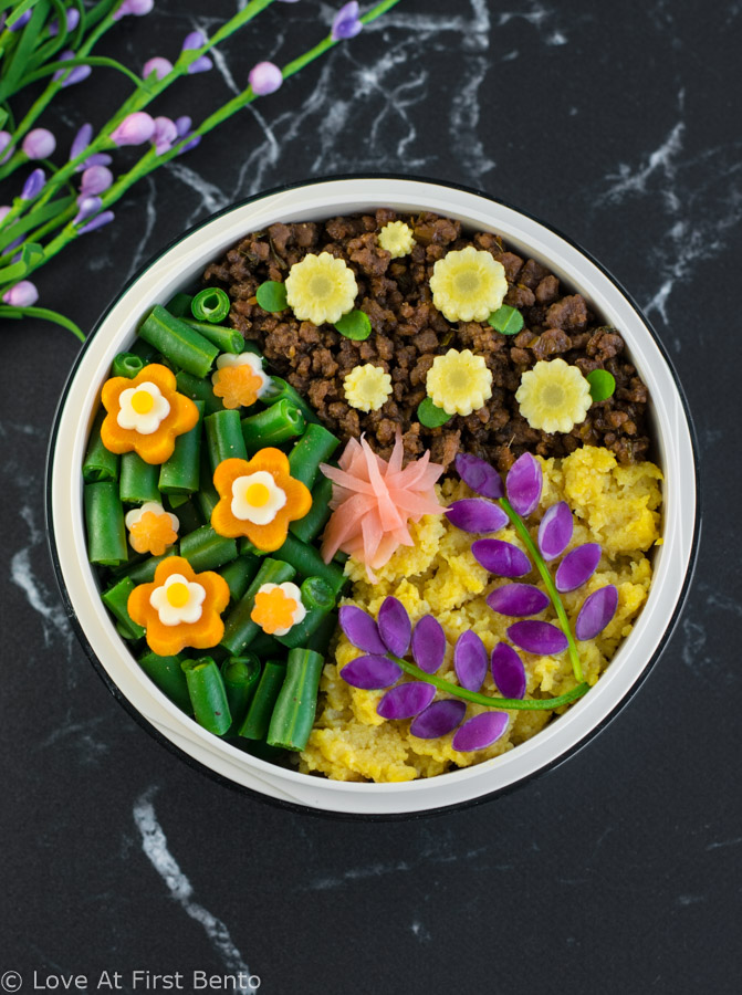 Flower Garden Soboro Bento Box - Learn how to easily make a beautiful flower garden soboro bento that's almost too pretty to eat! Plus, a secret tip that makes decorating even easier. Recipe at loveatfirstbento.com