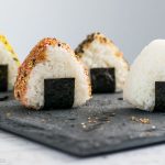 How to Make Onigiri (Rice Balls) - a classic bento recipe, made even simpler with the help of a rice mold. Learn just how easy it is to make this quintessential Japanese lunch item at www.loveatfirstbento.com (video tutorial included!)
