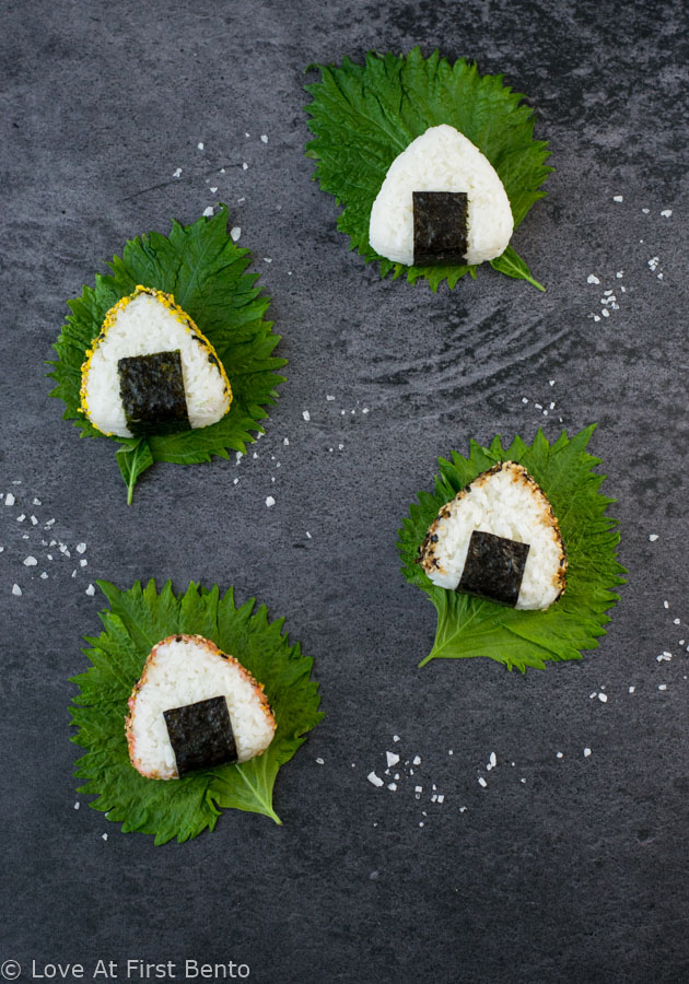 How to Make Onigiri (Rice Balls) - a classic bento recipe, made even simpler with the help of a rice mold. Learn just how easy it is to make this quintessential Japanese lunch item at www.loveatfirstbento.com (video tutorial included!)