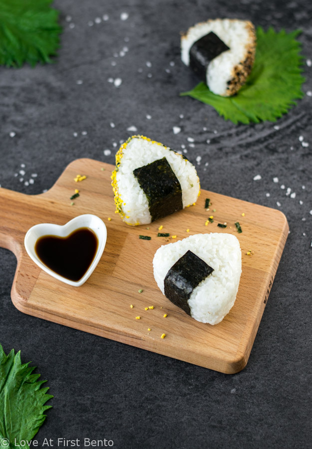 How to Make Onigiri (Rice Balls) - a classic bento recipe, made even simpler with the help of a rice mold. Learn just how easy it is to make this quintessential Japanese lunch item at www.loveatfirstbento.com (video tutorial included!)