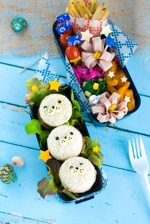 Mini Baby Seal Fish Burgers Bento Box - Learn how easy it is to make these adorable baby seals for lunch! Easy, delicious, and almost too cute to eat, they make the perfect addition to any nautical themed bento box. | loveatfirstbento.com