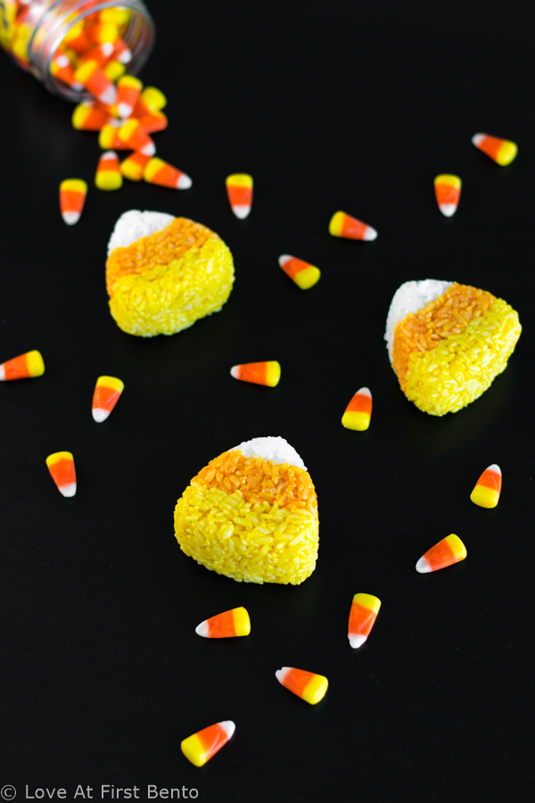 Candy Corn Onigiri (Rice Balls) - Easily transform your kid's bento box into a fun-filled Halloween lunch with these fun & festive onigiri! Find out how to make these 100% naturally colored rice balls with step-by-step instructions + video tutorial. A great, healthy alternative to regular Halloween candy! | loveatfirstbento.com [vegetarian, vegan]