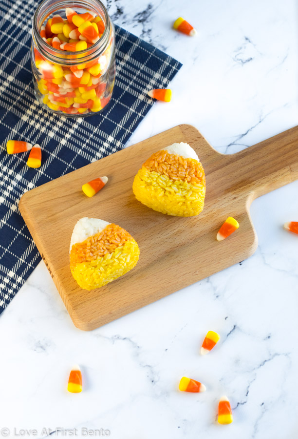 Candy Corn Onigiri (Rice Balls) - Easily transform your kid's bento box into a fun-filled Halloween lunch with these fun & festive onigiri! Find out how to make these 100% naturally colored rice balls with step-by-step instructions + video tutorial. A great, healthy alternative to regular Halloween candy! | loveatfirstbento.com [vegetarian, vegan]