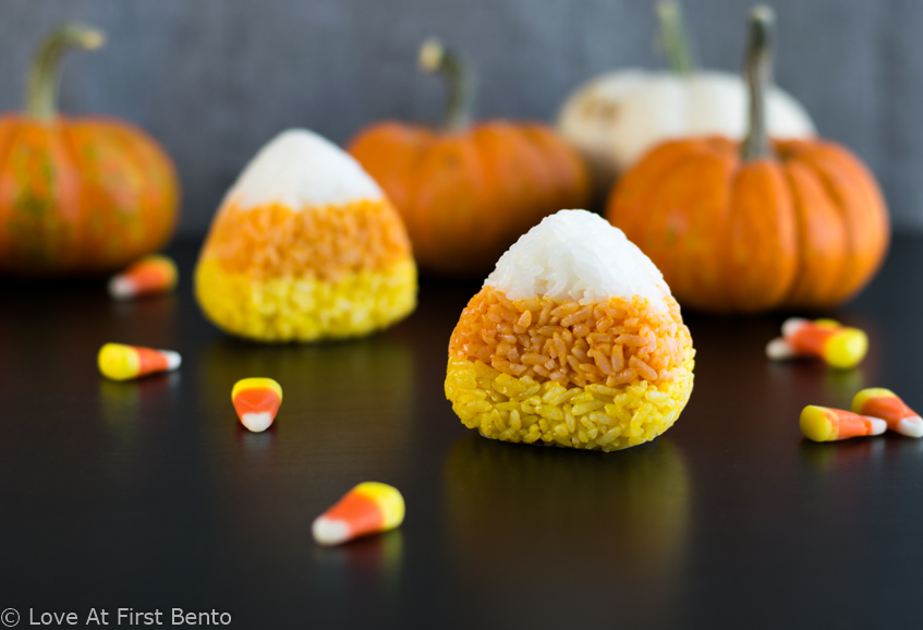 Candy Corn Onigiri (Rice Balls) - Easily transform your kid's bento box into a fun-filled Halloween lunch with these fun & festive onigiri! Find out how to make these 100% naturally colored rice balls with step-by-step instructions + video tutorial. A great, healthy alternative to regular Halloween candy! | loveatfirstbento.com [vegetarian, vegan]