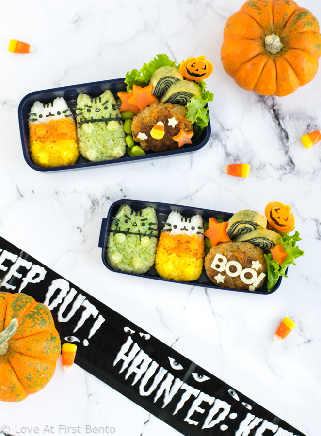 Halloween Pusheen Surprise Bento Box - Now you can experience the fun of the Halloween Pusheen Surprise Box in your lunch, thanks to this cute & festive character bento box! Learn step-by-step how to make Candy Corn Pusheen & Frankenstein Pusheen using a rice mold + all natural dyes - video tutorial included! | loveatfirstbento.com