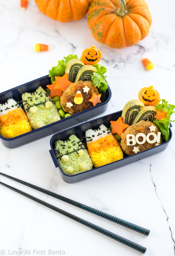 Halloween Pusheen Surprise Bento Box - Now you can experience the fun of the Halloween Pusheen Surprise Box in your lunch, thanks to this cute & festive character bento box! Learn step-by-step how to make Candy Corn Pusheen & Frankenstein Pusheen using a rice mold + all natural dyes - video tutorial included! | loveatfirstbento.com