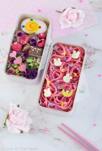Sailor Moon Noodles Bento Box - Learn exactly how to make this gorgeous character bento box that's fit for a moon princess! Featuring super easy naturally colored pink noodles, an edible mini Moon Stick, and an easy-to-follow video tutorial. Get the recipe at loveatfirstbento.com