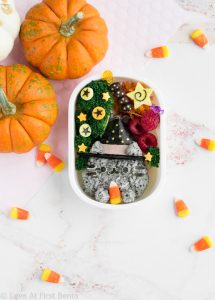 Witch Pusheen Halloween Bento Box - Make a Halloween lunch that's so cute, it's scary, thanks to the always adorable Pusheen the Cat! You won't be able to guess the 2 kitchen "magic tricks" used to make preparing this bento way faster & easier. Get the step-by-step instructions + video tutorial for this bento at: loveatfirstbento.com | charaben, kyaraben, character bento