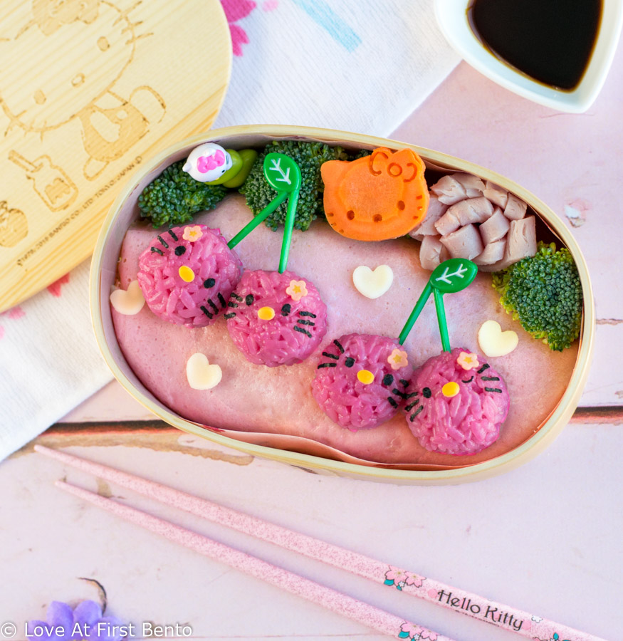 Hello Kitty Cherry Bento Box - The perfect lunch for any Hello Kitty fan, this pink & girly bento is so easy to make, it's nearly foolproof, making it perfect for beginner bento makers. Along with step-by-step instructions & video tutorial, find out the amazing tool I use to easily shape perfectly circular rice balls in just 30 seconds!! | loveatfirstbento.com [character bento, kyaraben, charaben, vegetarian]