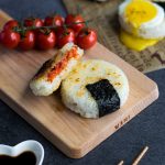Roasted Tomato Yaki Onigiri with Fried Egg - The ultimate in lunchtime decadence! Toasty golden rice, sweet roasted tomatoes, and a runny fried egg transform your average rice ball into an irresistibly mouth-watering treat! Find out the one common kitchen tool used to make these circular onigiri - I guarantee it's in your kitchen drawers right now! Get this delicious & easy recipe at loveatfirstbento.com | bento box, Japanese food, grill