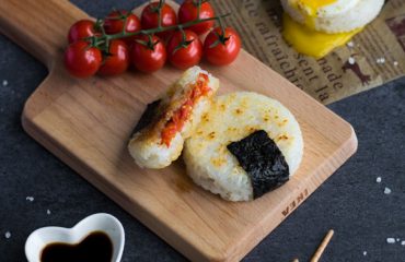 Roasted Tomato Yaki Onigiri with Fried Egg - The ultimate in lunchtime decadence! Toasty golden rice, sweet roasted tomatoes, and a runny fried egg transform your average rice ball into an irresistibly mouth-watering treat! Find out the one common kitchen tool used to make these circular onigiri - I guarantee it's in your kitchen drawers right now! Get this delicious & easy recipe at loveatfirstbento.com | bento box, Japanese food, grill