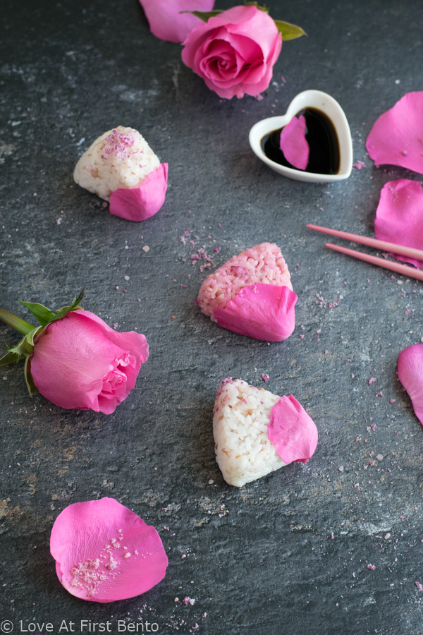 Salted Rose Onigiri - WOW your friends with the unique flavor of pickled rose petals, which take these rice balls to a whole new level of edible elegance! Plus, I reveal a super easy, 2-ingredient rose salt recipe perfect for sprinkling on top. These onigiri are absolutely perfect for a Mother's Day or spring bento box - a guaranteed crowd-pleaser! Get the recipe at loveatfirstbento.com