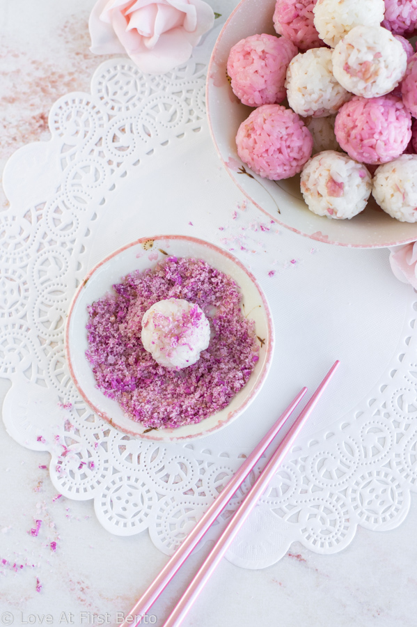 Salted Rose Onigiri - WOW your friends with the unique flavor of pickled rose petals, which take these rice balls to a whole new level of edible elegance! Plus, I reveal a super easy, 2-ingredient rose salt recipe perfect for sprinkling on top. These onigiri are absolutely perfect for a Mother's Day or spring bento box - a guaranteed crowd-pleaser! Get the recipe at loveatfirstbento.com