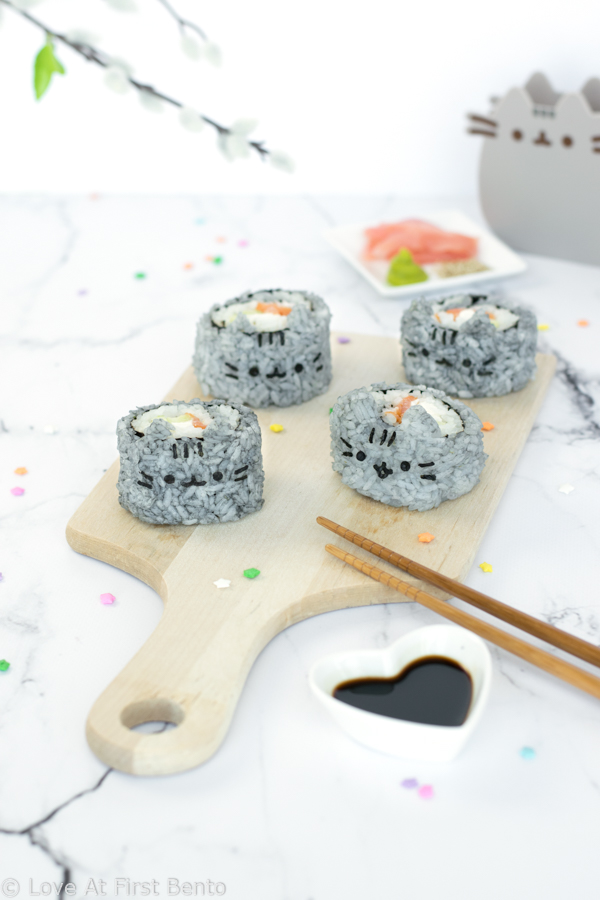 Pusheen Sushi (AKA Susheen) - Quite possibly the cutest sushi in the world, these Pusheen the Cat sushi rolls are not only adorably delicious, but colored using 100% natural ingredients! Perfect for packing into bento boxes, bringing on a picnic, or serving at a party. Guaranteed to be a hit with Pusheen fans of all ages! Get the recipe at: loveatfirstbento.com
