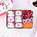 Hello Kitty Sushi Bento - Beautify your lunch with this Hello Kitty Sushi Bento! Filled with adorable Hello Kitty sushi rolls, as well as pink gingham flower sushi rolls, this pretty bento box is an edible dream come true for any Hello Kitty fan! Find out just how easy it is to make by visiting loveatfirstbento.com [character bento, kyaraben, deco sushi]